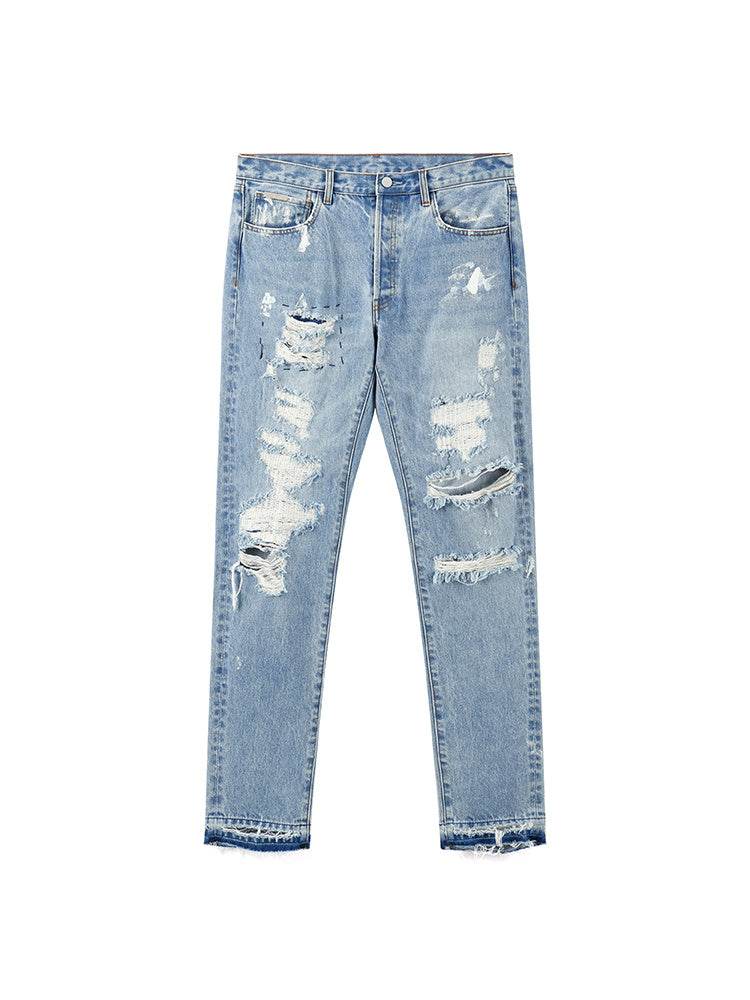 Distressed Washed Retro Light-colored Jeans With Ripped Raw Edges MuddyStock