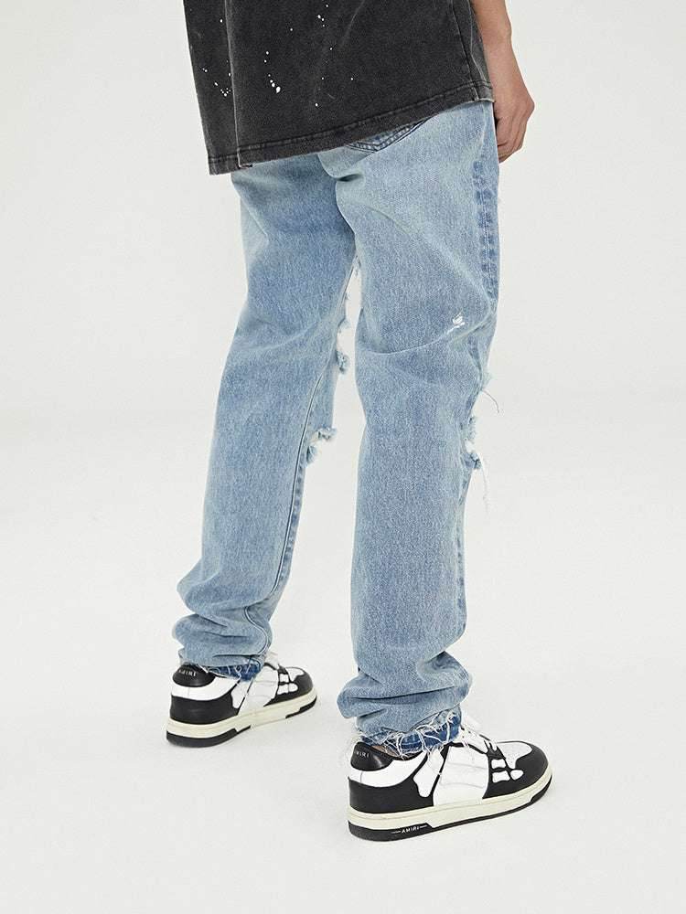 Distressed Washed Retro Light-colored Jeans With Ripped Raw Edges MuddyStock